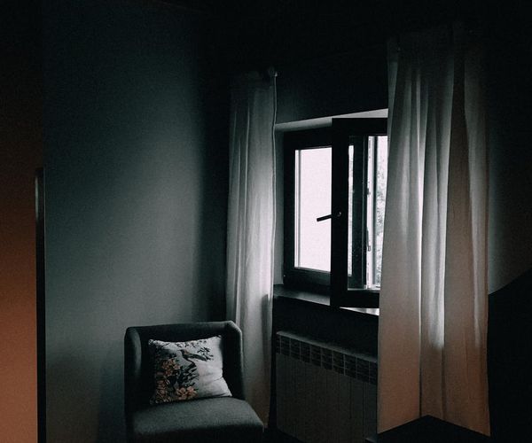 A calm and minimalist corner of a room with a comfortable chair.