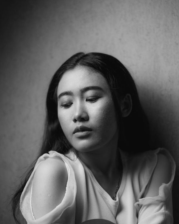 A serene woman with closed eyes, focusing inward.